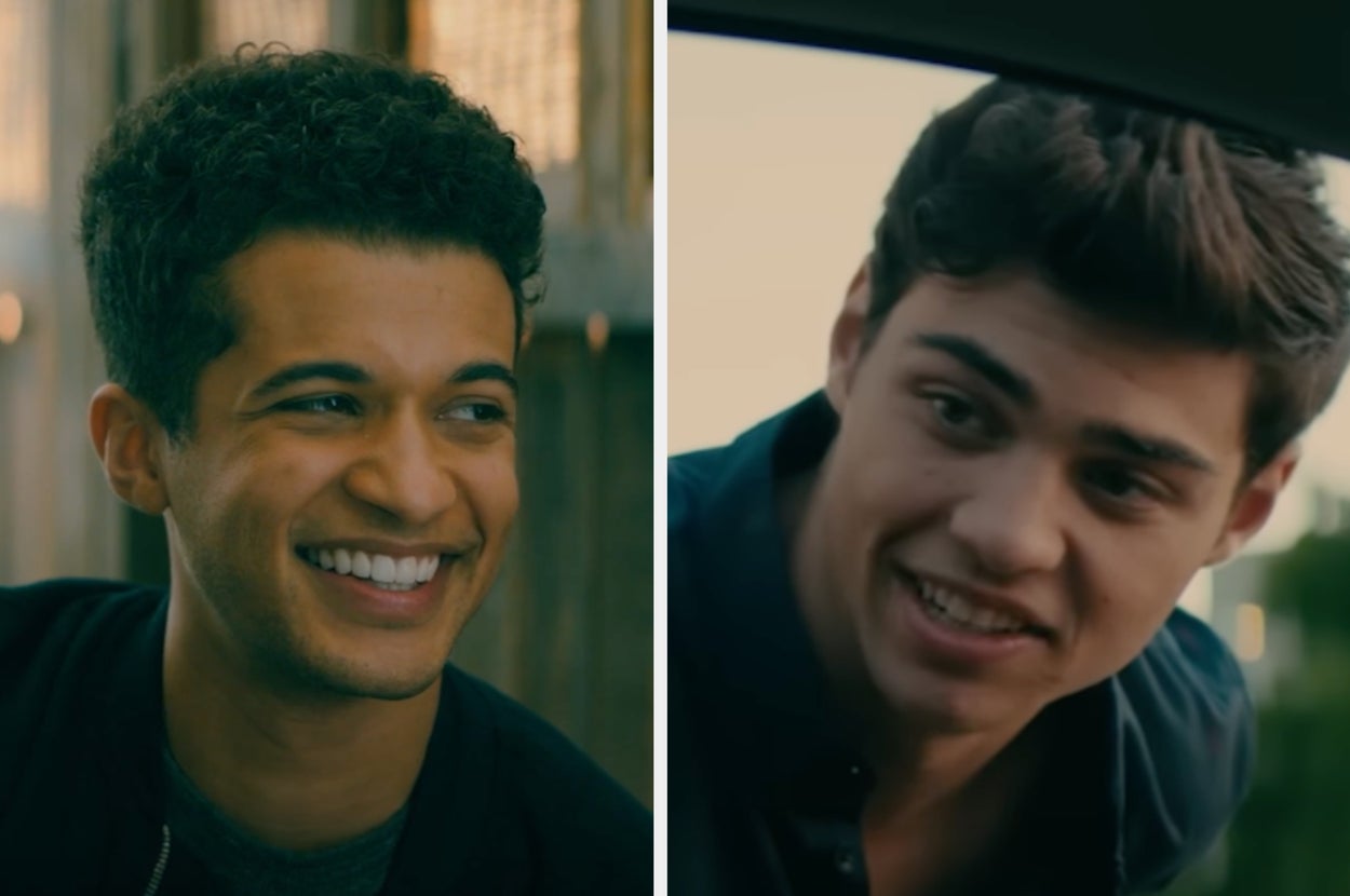 Two young men smiling, both facing slightly towards the camera. They appear to be in a casual setting