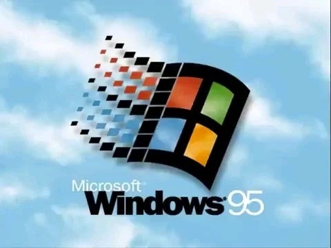 Windows 95 logo with pixelated squares, iconic Microsoft branding, set against a cloud-filled sky