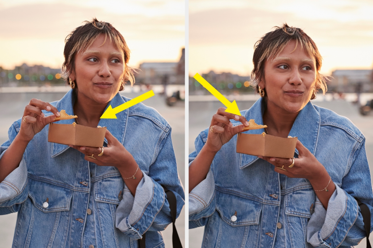 Person outdoors enjoying a bite of food from a cardboard tray, wearing a denim jacket. Yellow arrows highlight gestures or movement