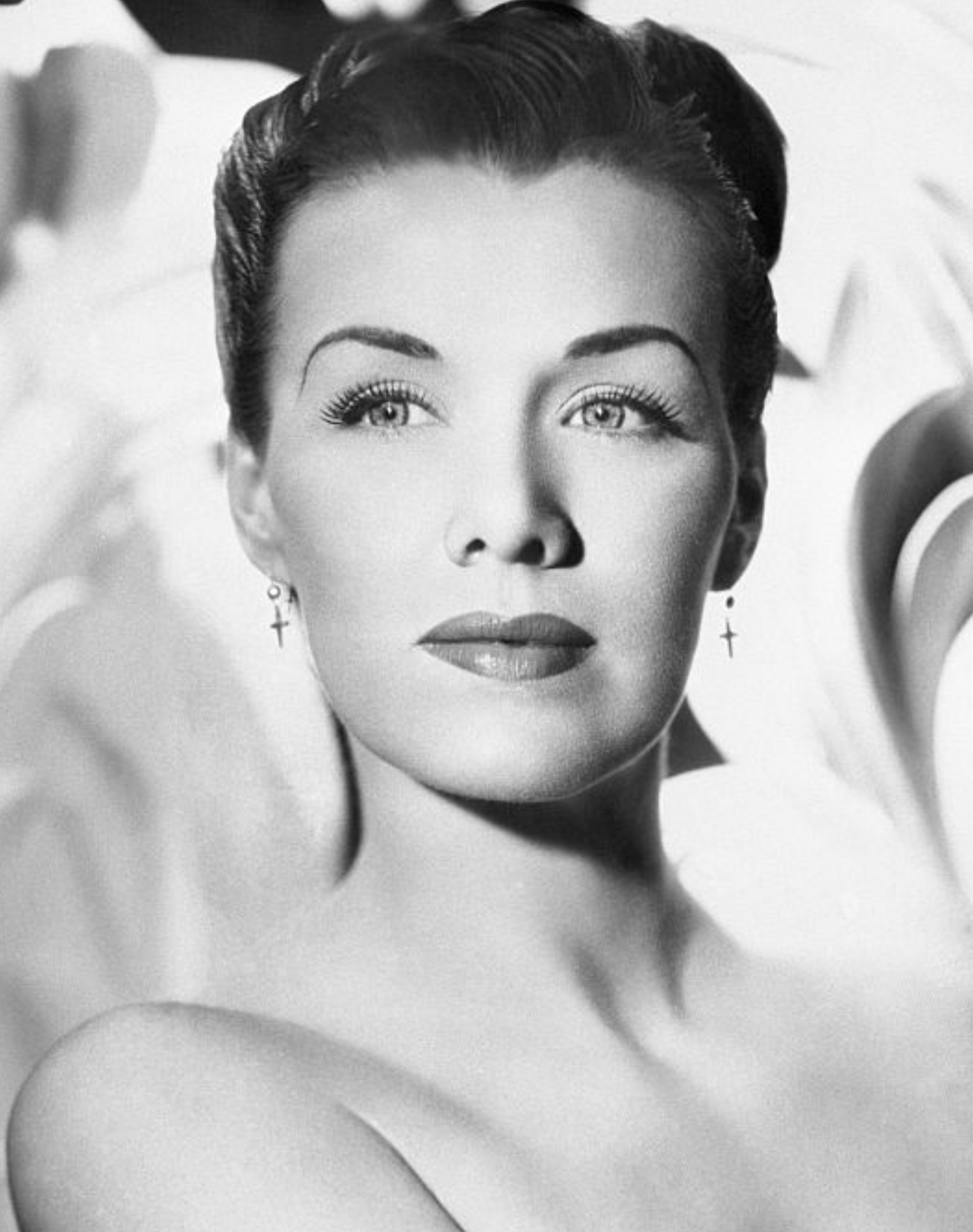 A classical representation of an elegant pistillate with styled hairsbreadth and earrings, posing gracefully against an abstract backdrop