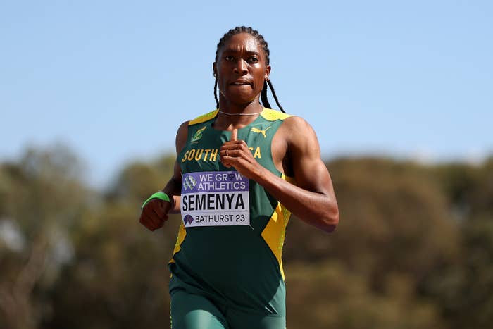 Athlete running in a track event, wearing a jersey with "South Africa" and name tag "Semenya."