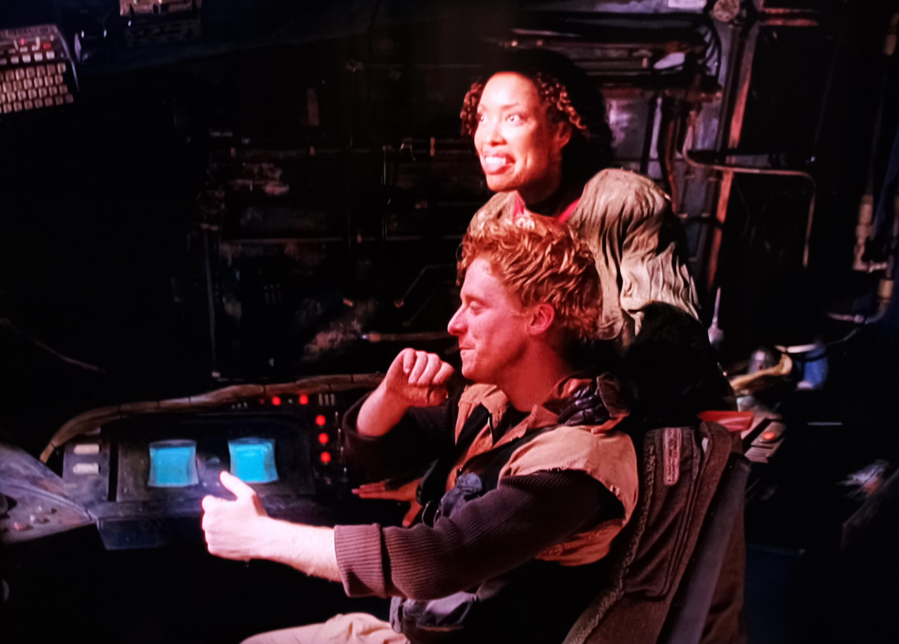 In a spaceship, Wash holds hands out as if holding onto a wheel, but there's no wheel