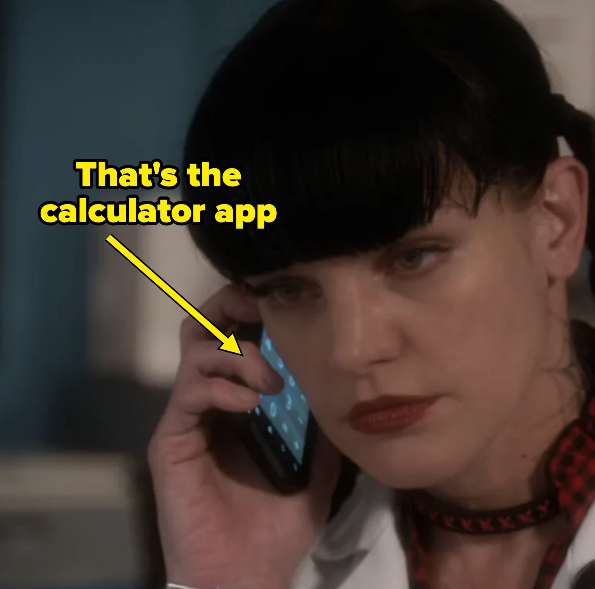 Abby with a phone to her ear. You can see the calculator app up
