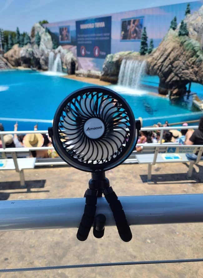 Portable instrumentality   with flexible tripod mounted connected  a railing