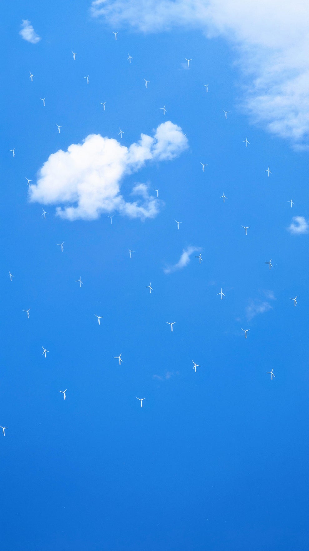 Sky with white clouds interspersed with tiny wind turbines, creating an illusionary landscape of renewable energy devices floating in the air