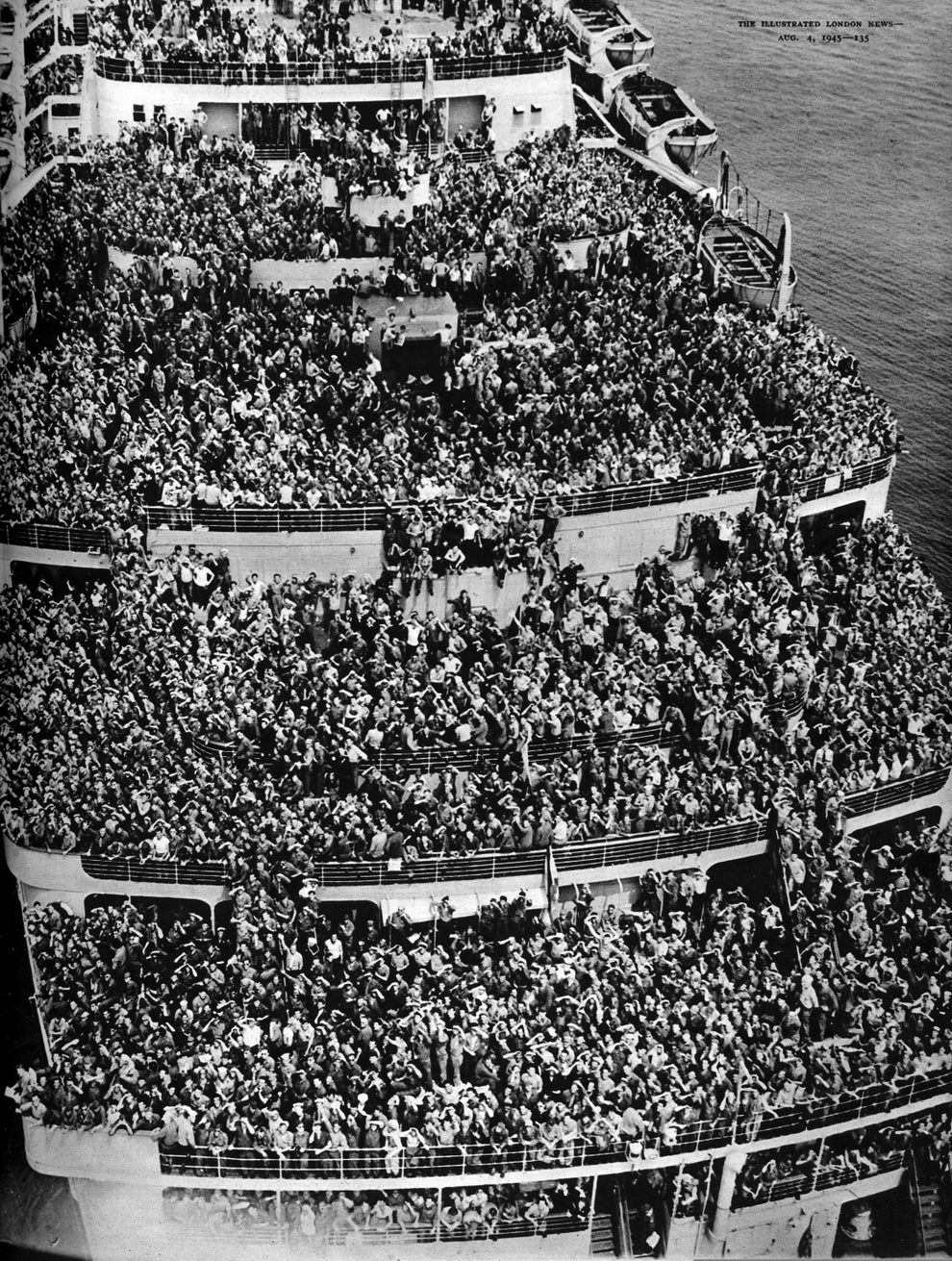 Crowded ship deck with countless people, likely passengers from post-war return, tightly packed and filling every visible space on multiple levels