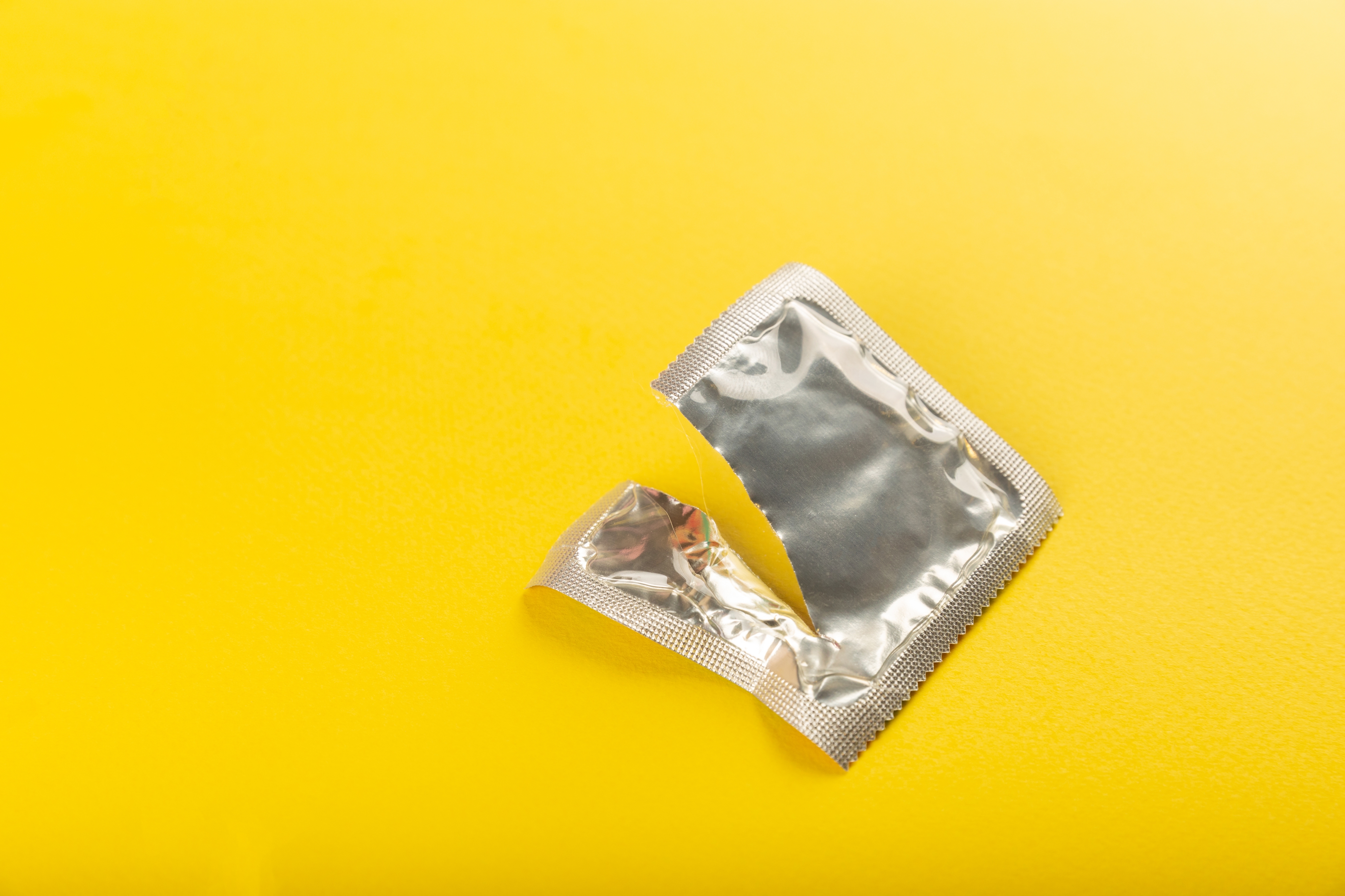 Opened silver blister pack on a plain background