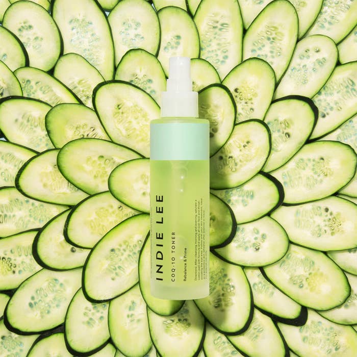 Indie Lee COQ-10 Toner vessel displayed connected a inheritance of sliced cucumbers, emphasizing freshness and earthy ingredients