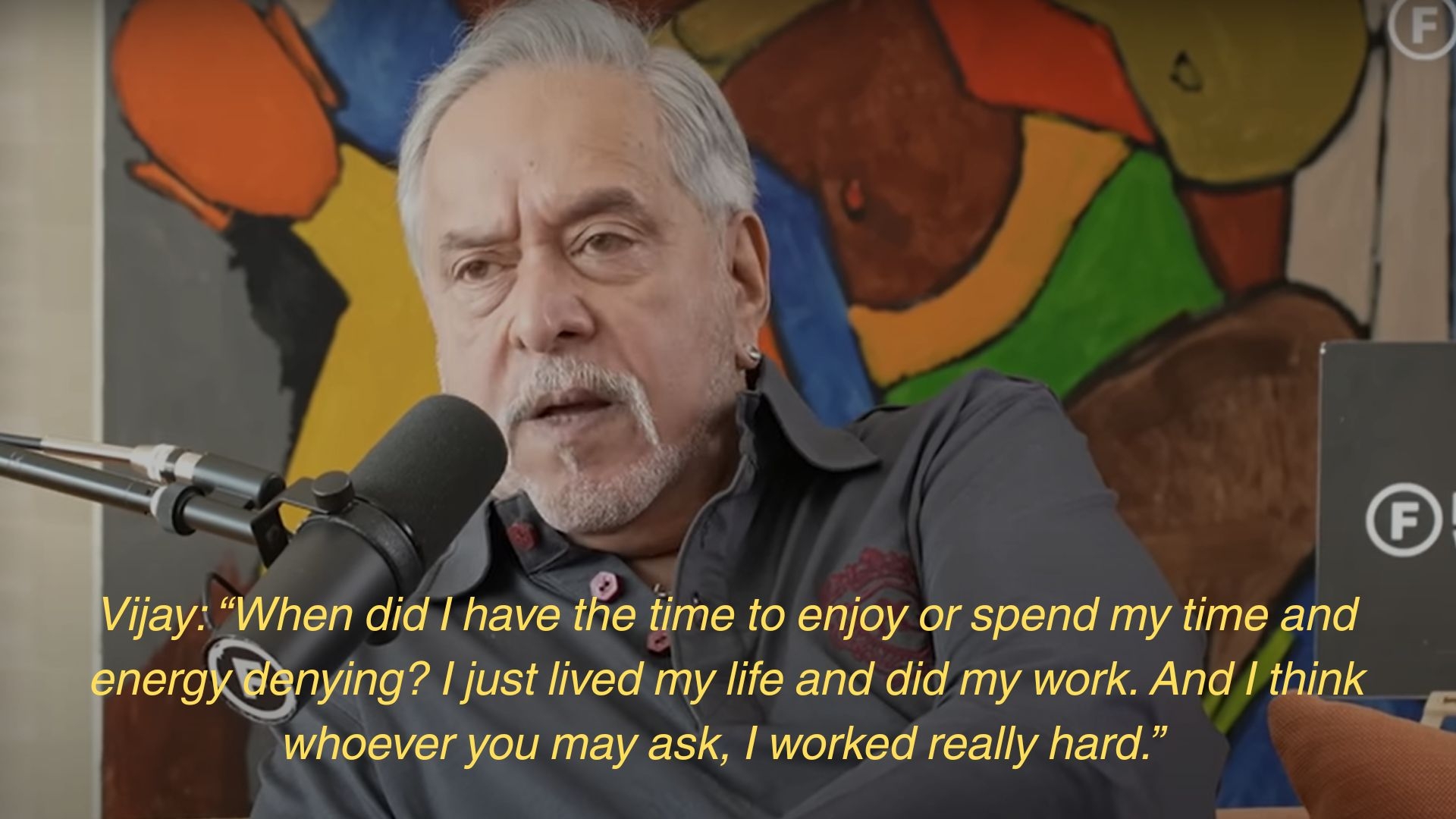 A man with a microphone on a podcast speaks, saying he worked hard and lived his life without denying or overthinking enjoyment