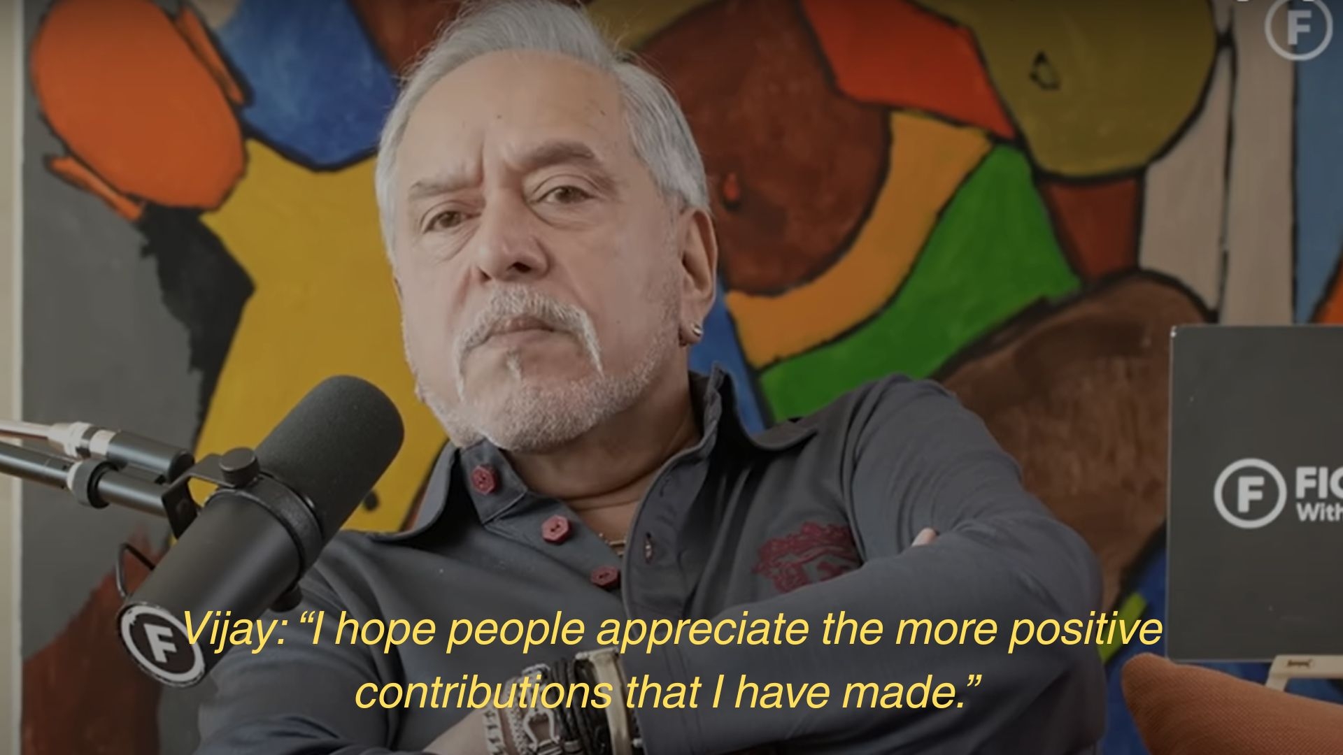 A person with gray hair and mustache speaking into a microphone, with a quote: "I hope people appreciate the more positive contributions that I have made."