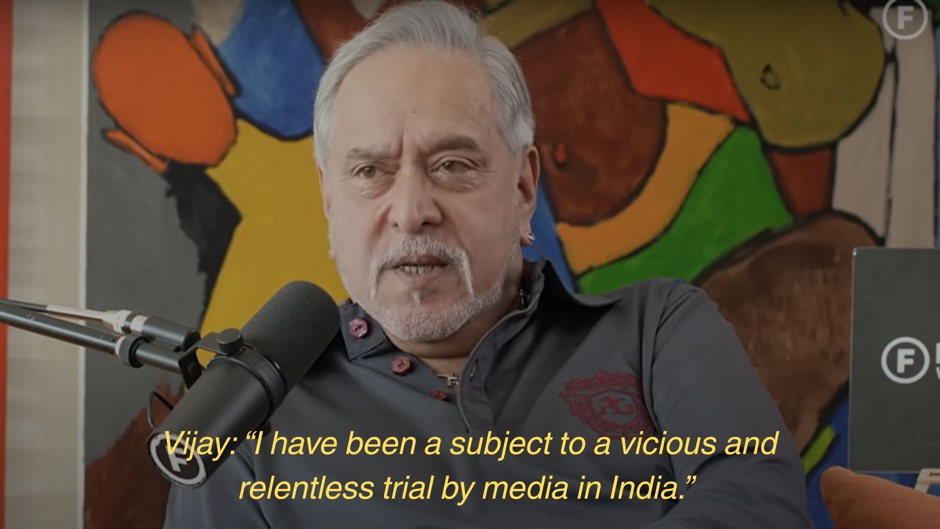 A person speaking into a microphone with text stating they've been subject to media trials in India