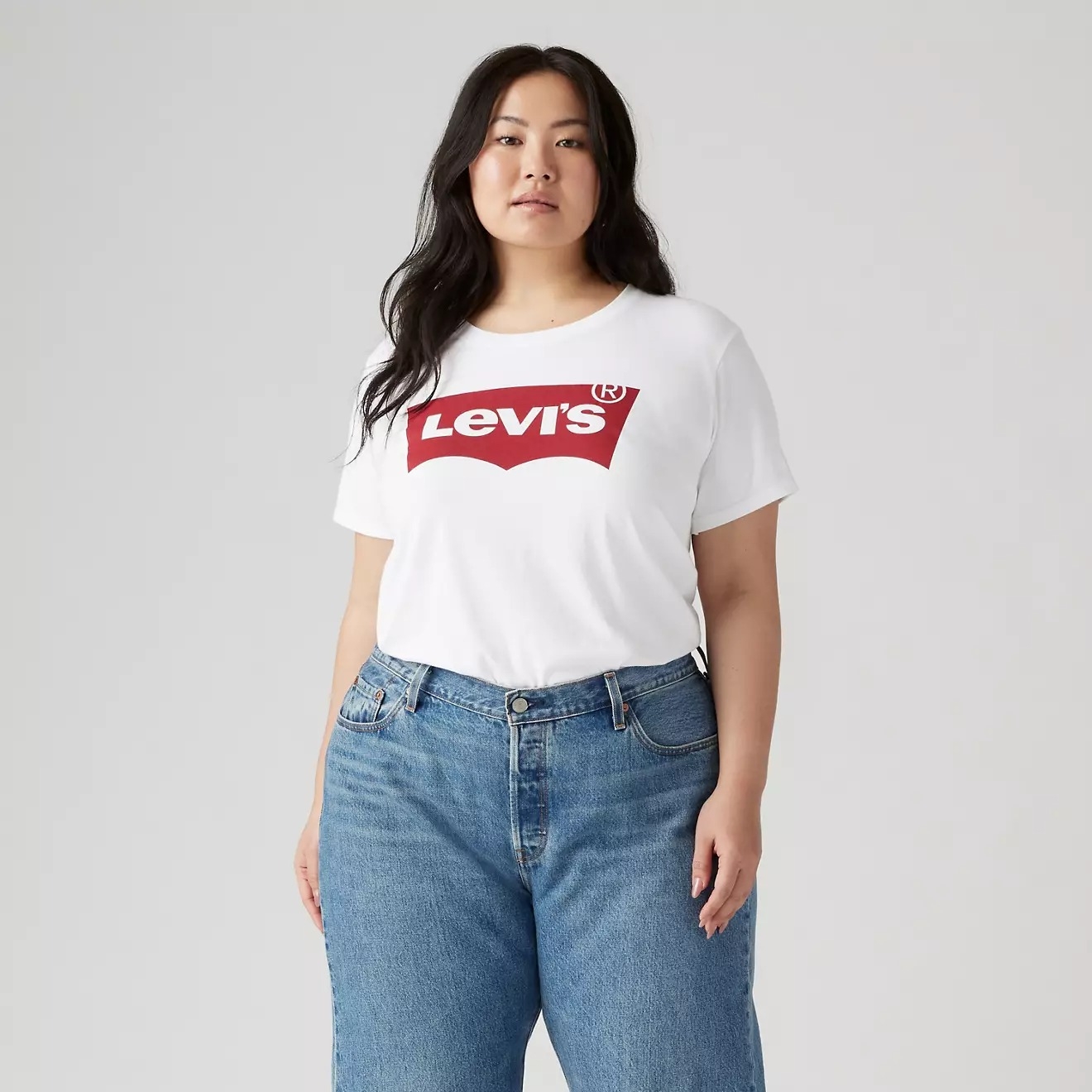 Person wearing a Levi's T-shirt and jeans, posing confidently
