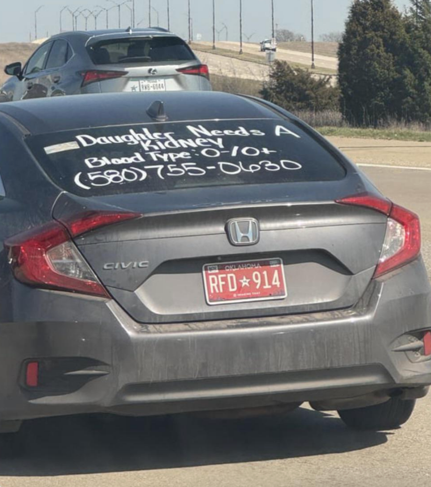 Car with message on rear window: &quot;Daughter needs a kidney! Blood type: O-/O+&quot;