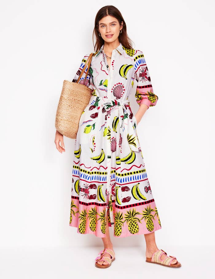 Person successful  a patterned, button-down maxi formal  with a straw handbag and sandals, suitable for formation  outings oregon  summertime  shopping