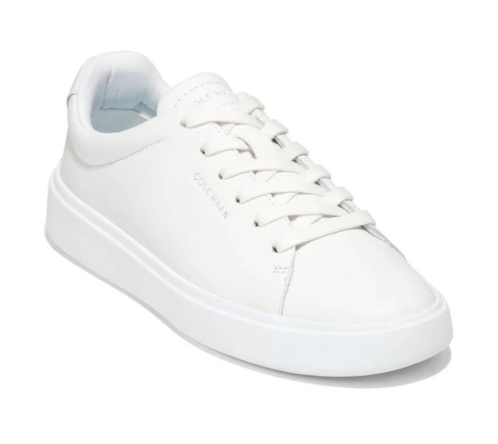 White casual sneaker with a low-top design, featuring laces and a textured sole, ideal for everyday wear