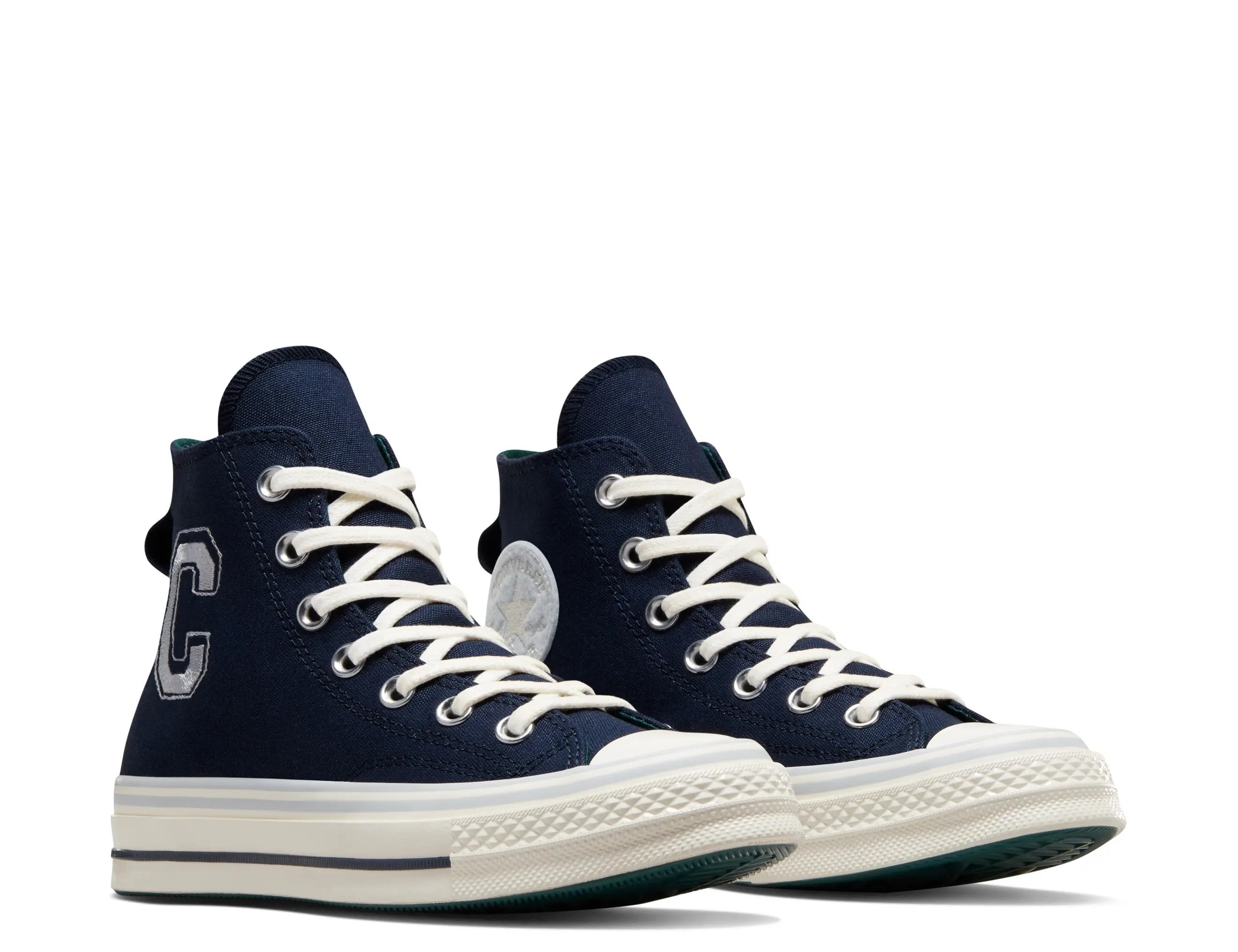 High-top sneakers with a letter &quot;C&quot; on the side, featuring white laces and soles