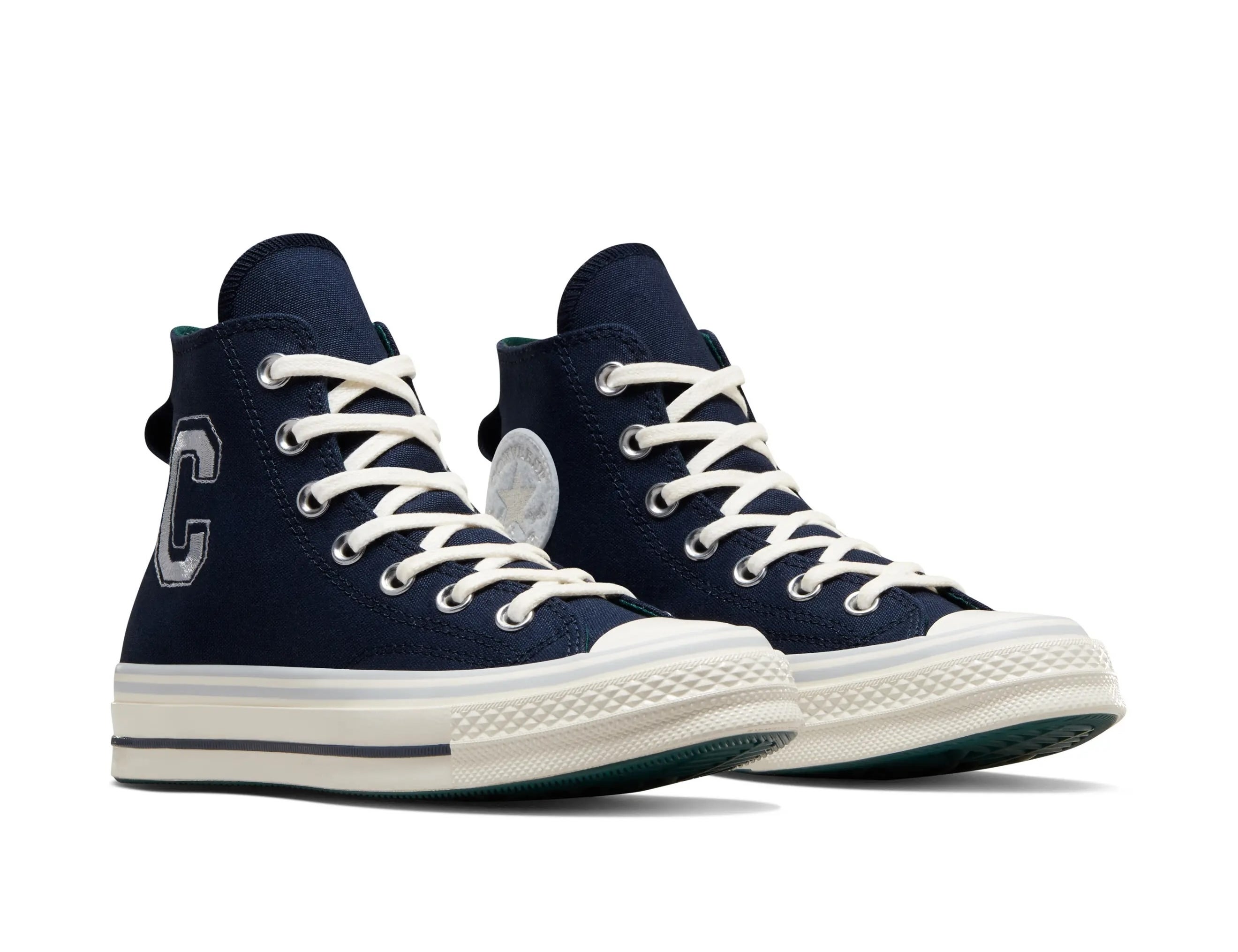 High-top sneakers with a letter "C" on the side, featuring white laces and soles