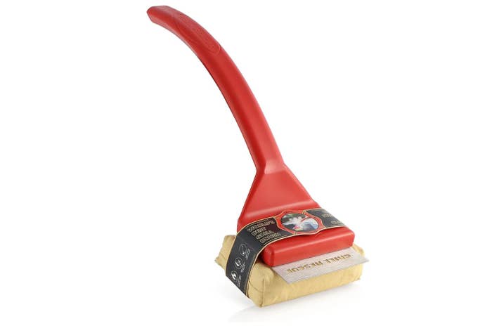 Grill cleaning brush with a long red handle and a detachable scrub pad. Suitable for removing grease and grime from barbecue grates