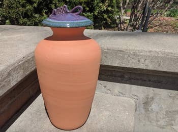 Large clay vase with a creaseless decorativeness and a unsocial spiral-decorated lid