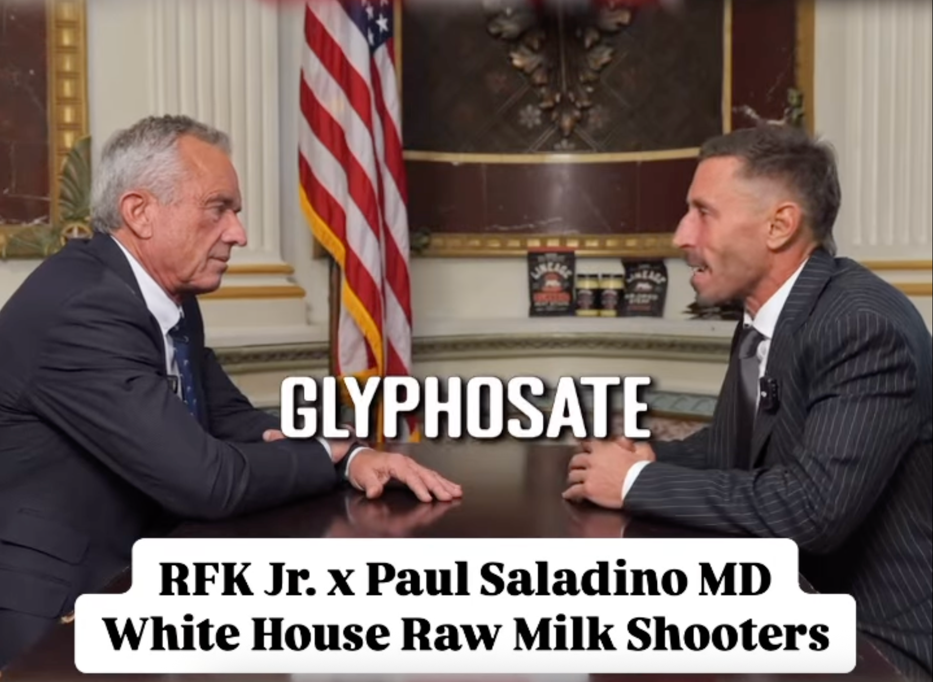 Two individuals engaged in a discussion at a table discussing glyphosate. Caption: &quot;RFK Jr. x Paul Saladino MD White House Raw Milk Shooters&quot;