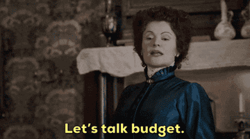 A person in period costume gestures with confidence as the words &quot;Let&#x27;s talk budget&quot; appear below