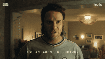 A person angrily declares, &quot;I&#x27;m an agent of chaos,&quot; in a dimly lit room. Text and Hulu logo are displayed