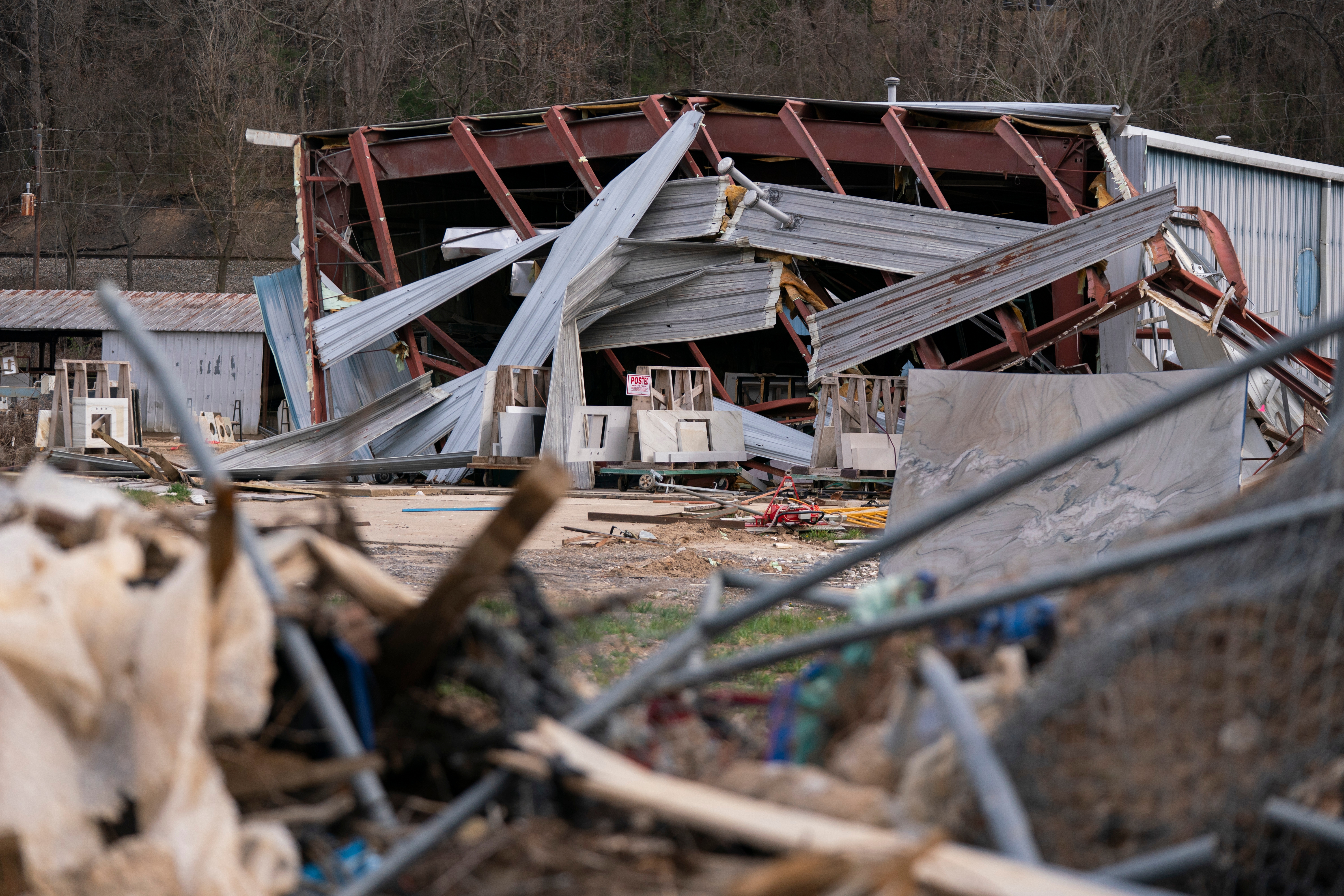 Collapsed metal structure with debris scattered around due to damage from Hurrican Helene in North Carolina