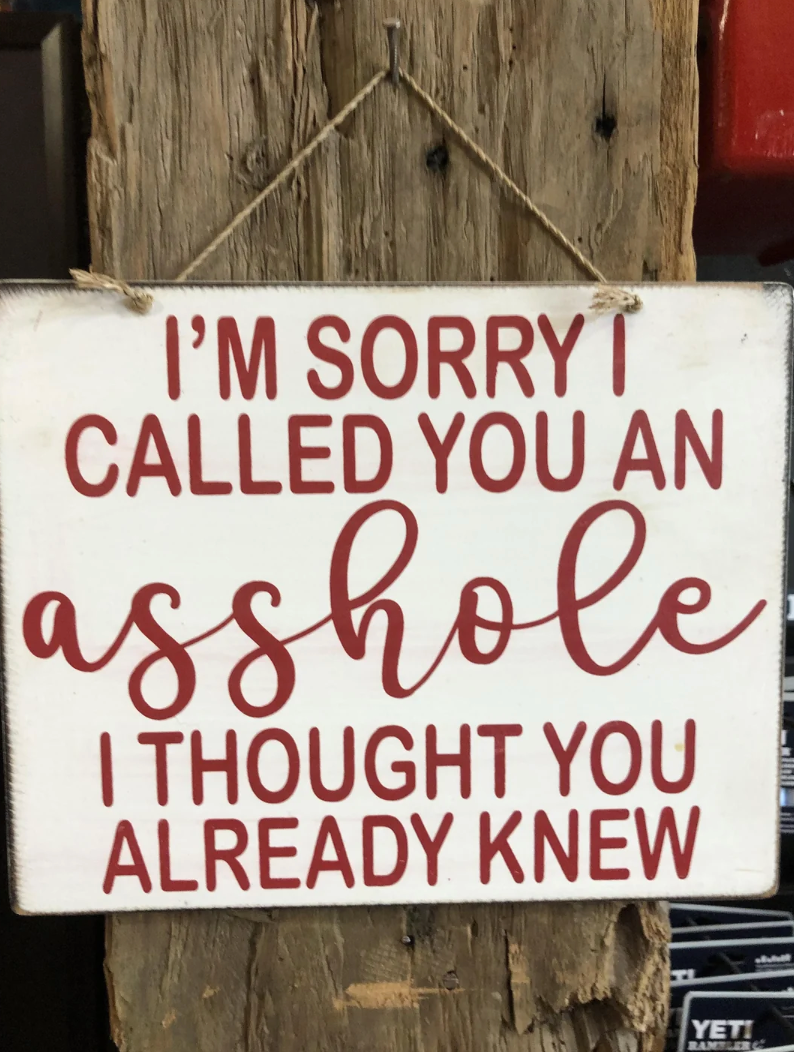 Sign connected  a woody  station  says, "I'm atrocious   I called you an asshole. I thought   you already knew."