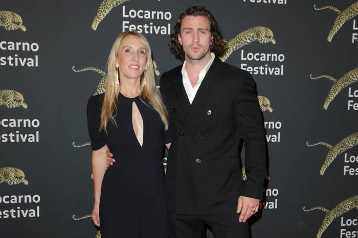 A couple poses at the Locarno Festival. The woman wears a sleek black dress; the man is in a tailored black suit
