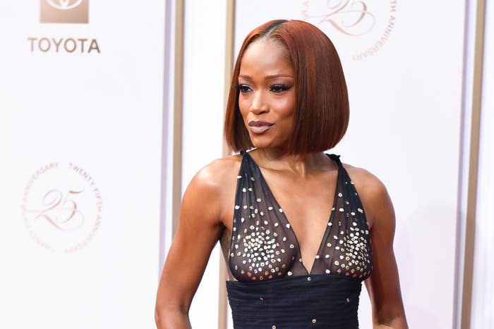 Keke Palmer wearing a sleeveless, embellished gown with a plunging neckline on a red carpet