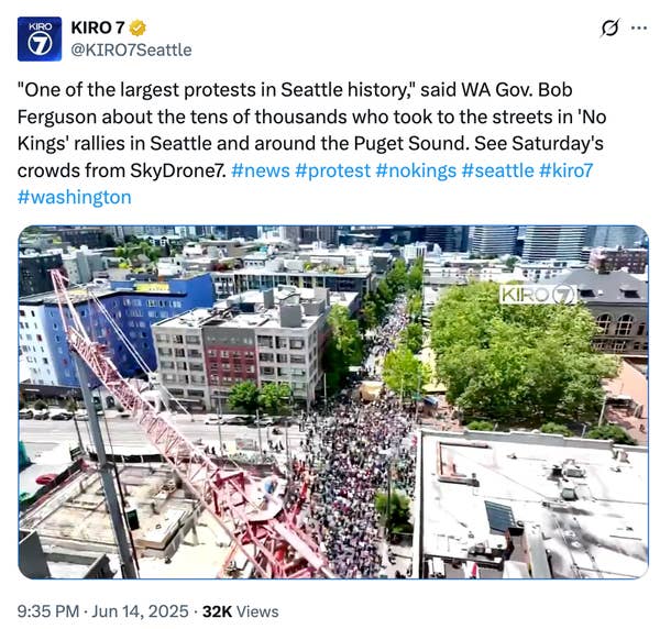A protest in Seattle draws thousands, seen from above. The crowd fills the streets near construction sites and green spaces