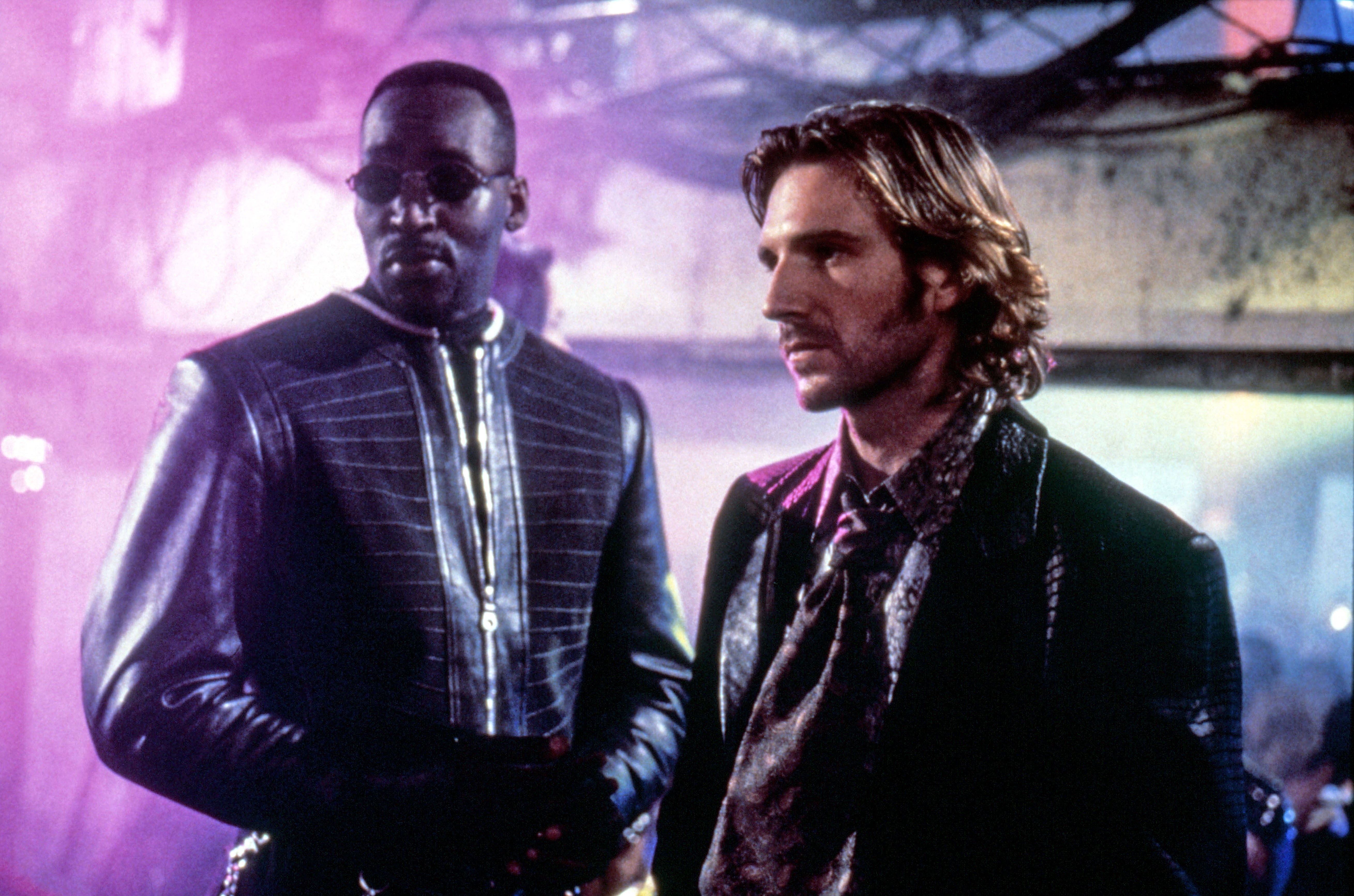 Two individuals successful  futuristic attire basal   successful  a neon-lit setting, appearing focused and intense