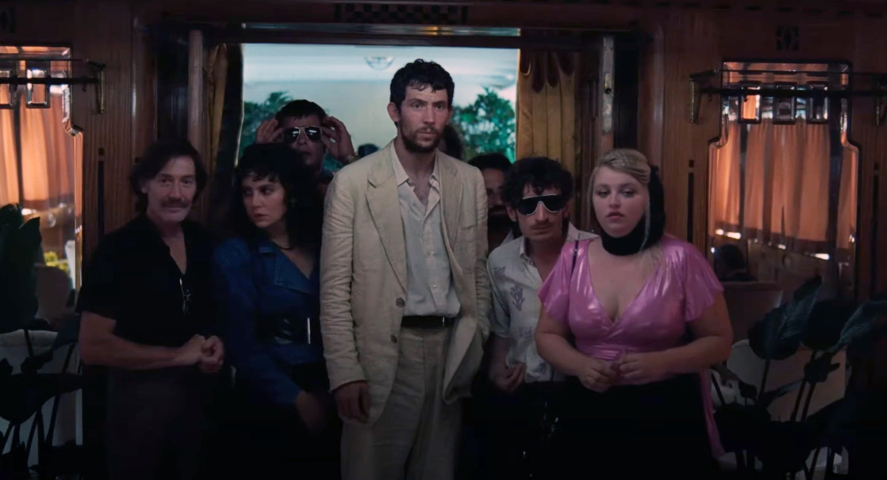 A radical  of people, including 1  successful  a airy  suit   and different  successful  a shimmering top, basal   successful  a dimly lit room, looking amazed  oregon  concerned