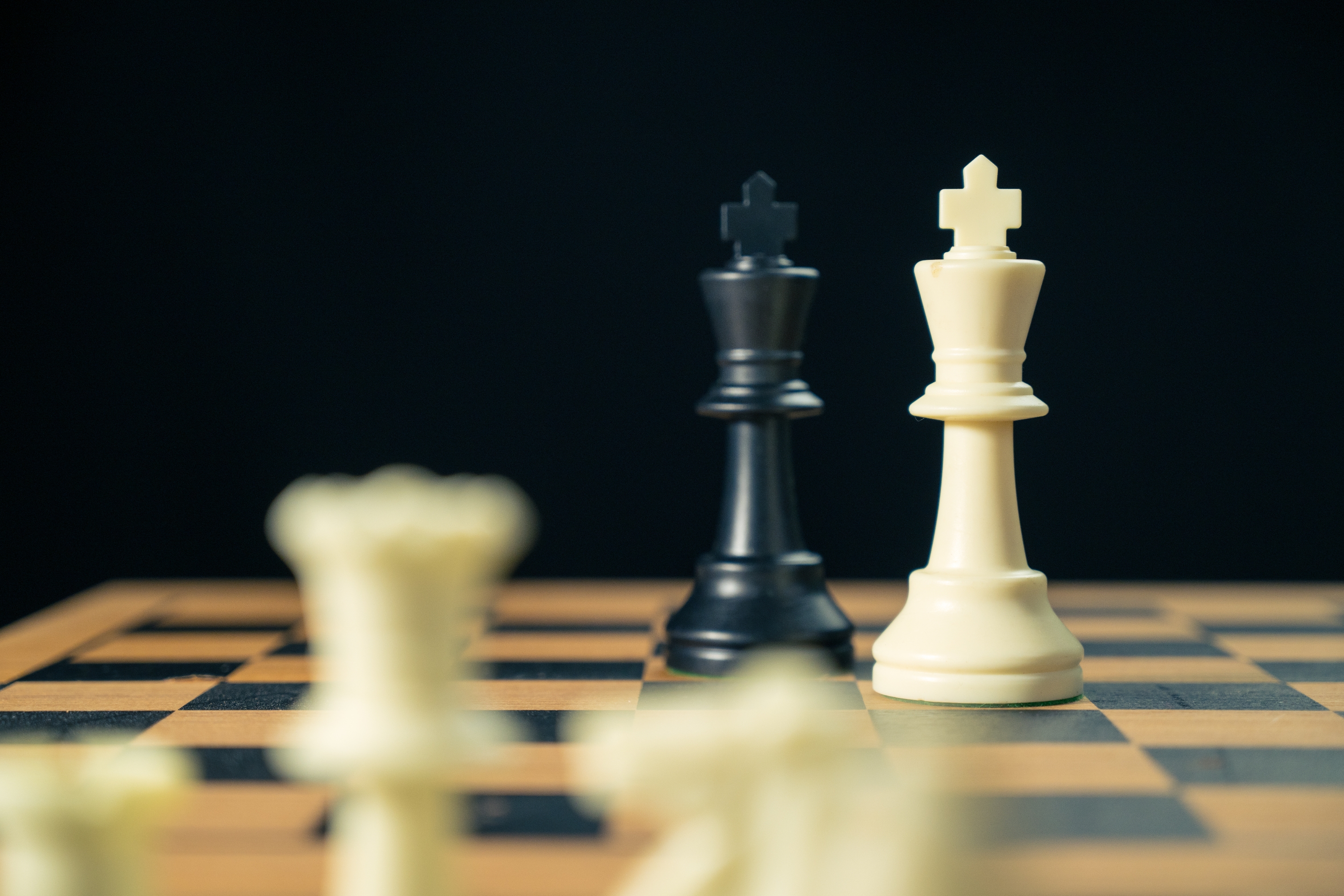 Two chess kings facing off on a chessboard, symbolizing a strategic face-off or metaphorical relationship dynamic