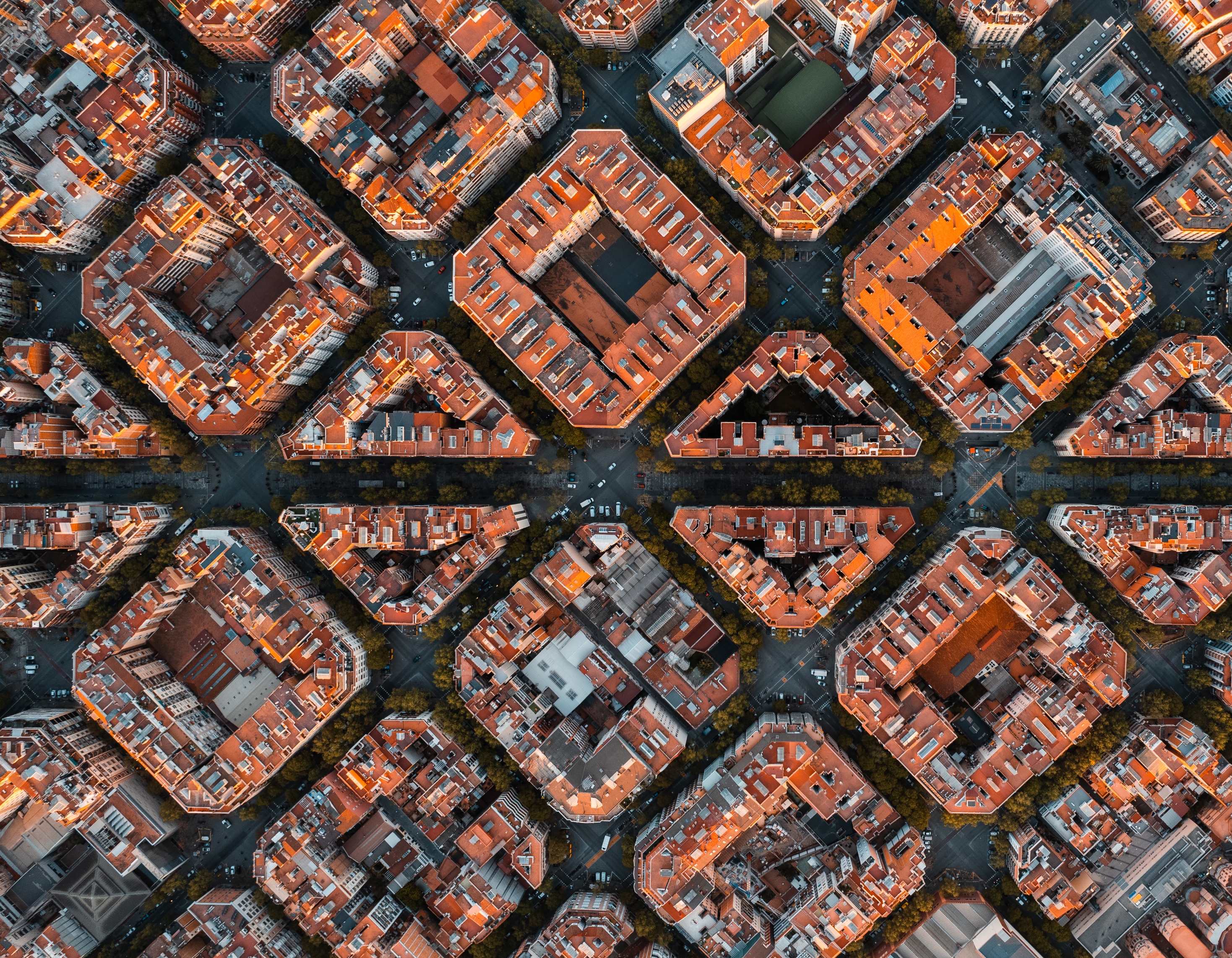 Aerial view of a city grid showcasing unique, geometric rooftop patterns and symmetrical blocks