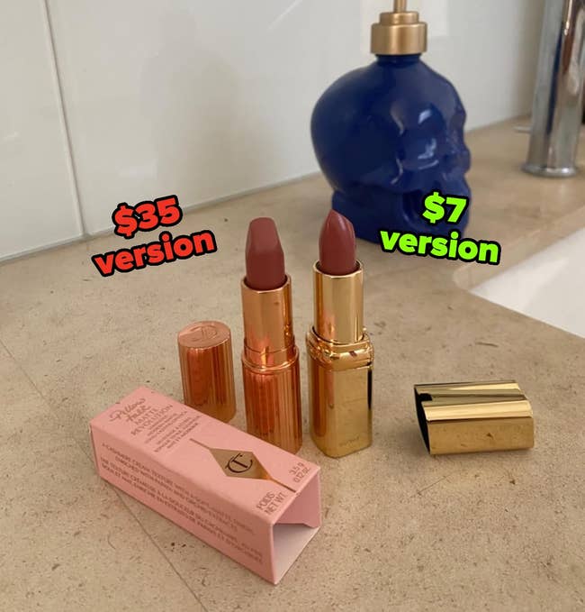 Two lipsticks, 1 with a headdress off, adjacent to a pinkish container connected a bath antagonistic with a bluish skull-shaped soap dispenser successful the background