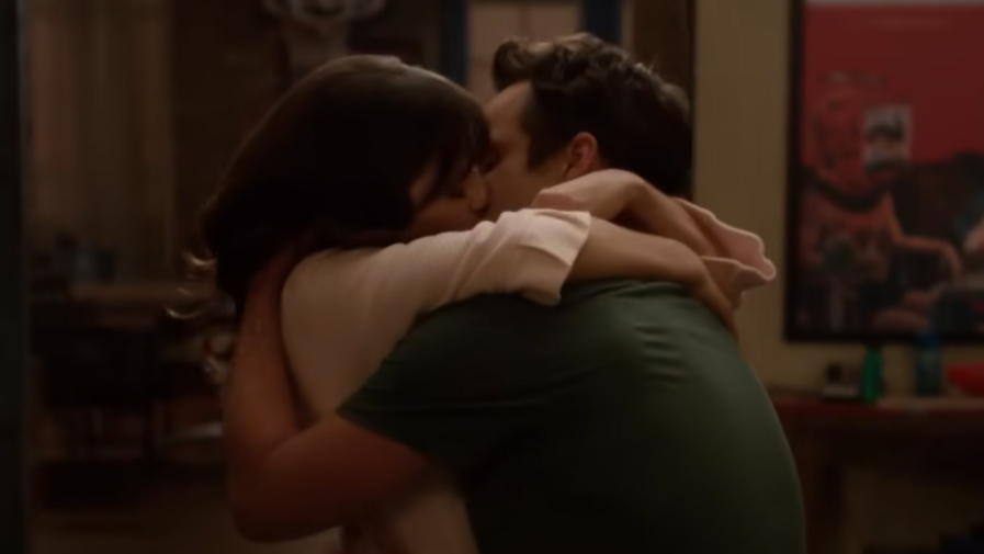Jess and Nick with their arms tightly around each other while they kiss