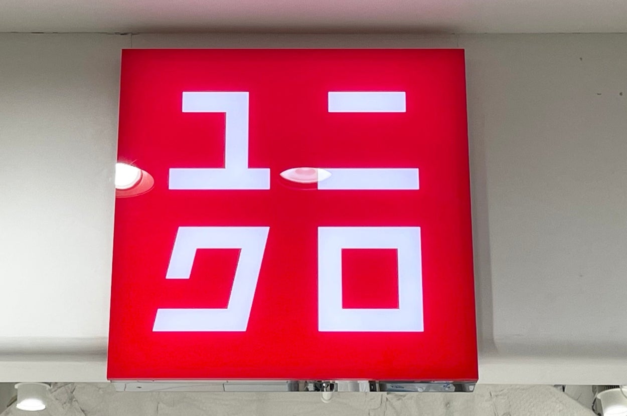 Japanese characters on a red Uniqlo store sign inside a retail location