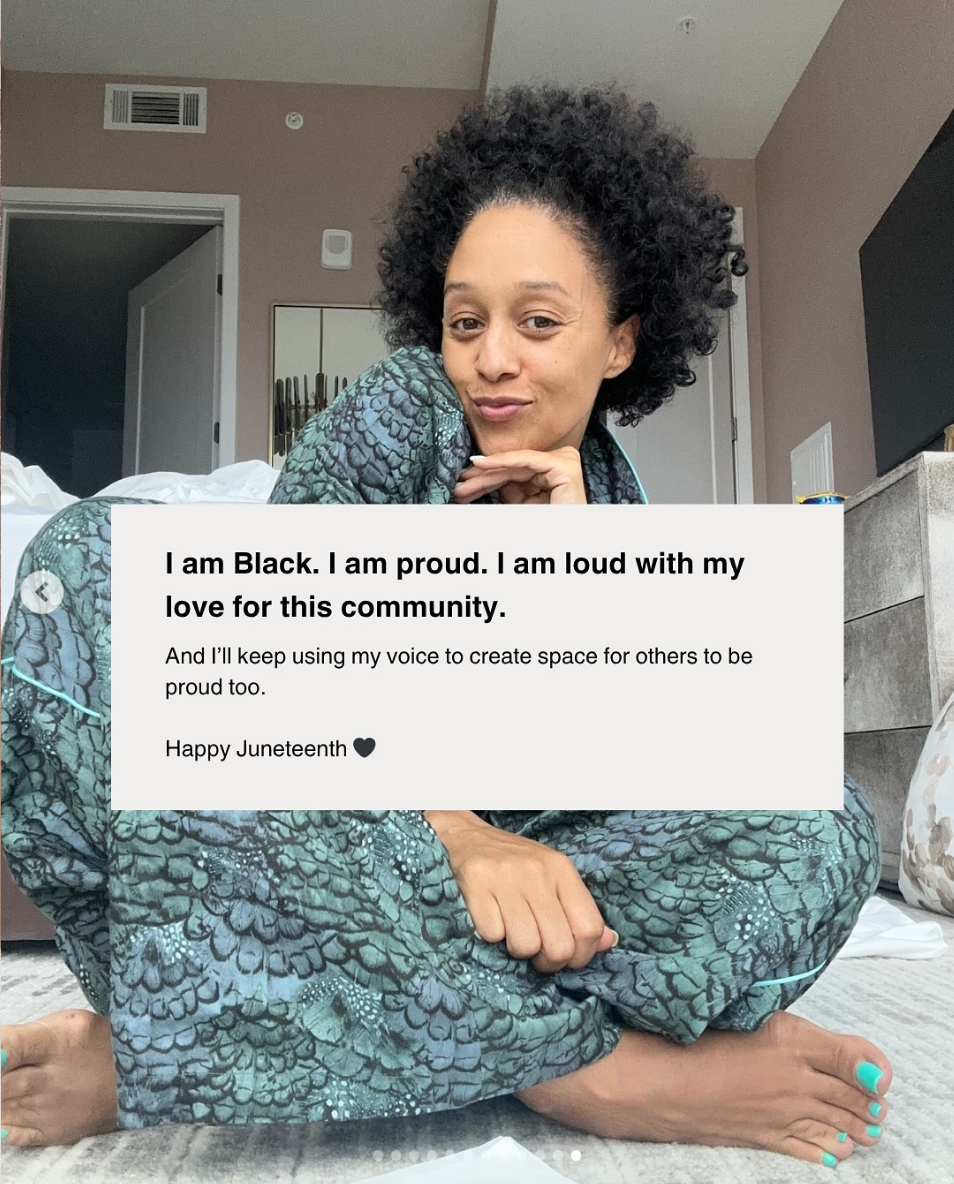 Person in patterned outfit sits indoors with text overlay expressing pride and commitment to the Black community. Message wishes a happy Juneteenth
