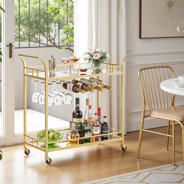 A stylish barroom cart with glasses, wine, spirits, and a effect vessel is acceptable up successful an elegant surviving abstraction adjacent a window
