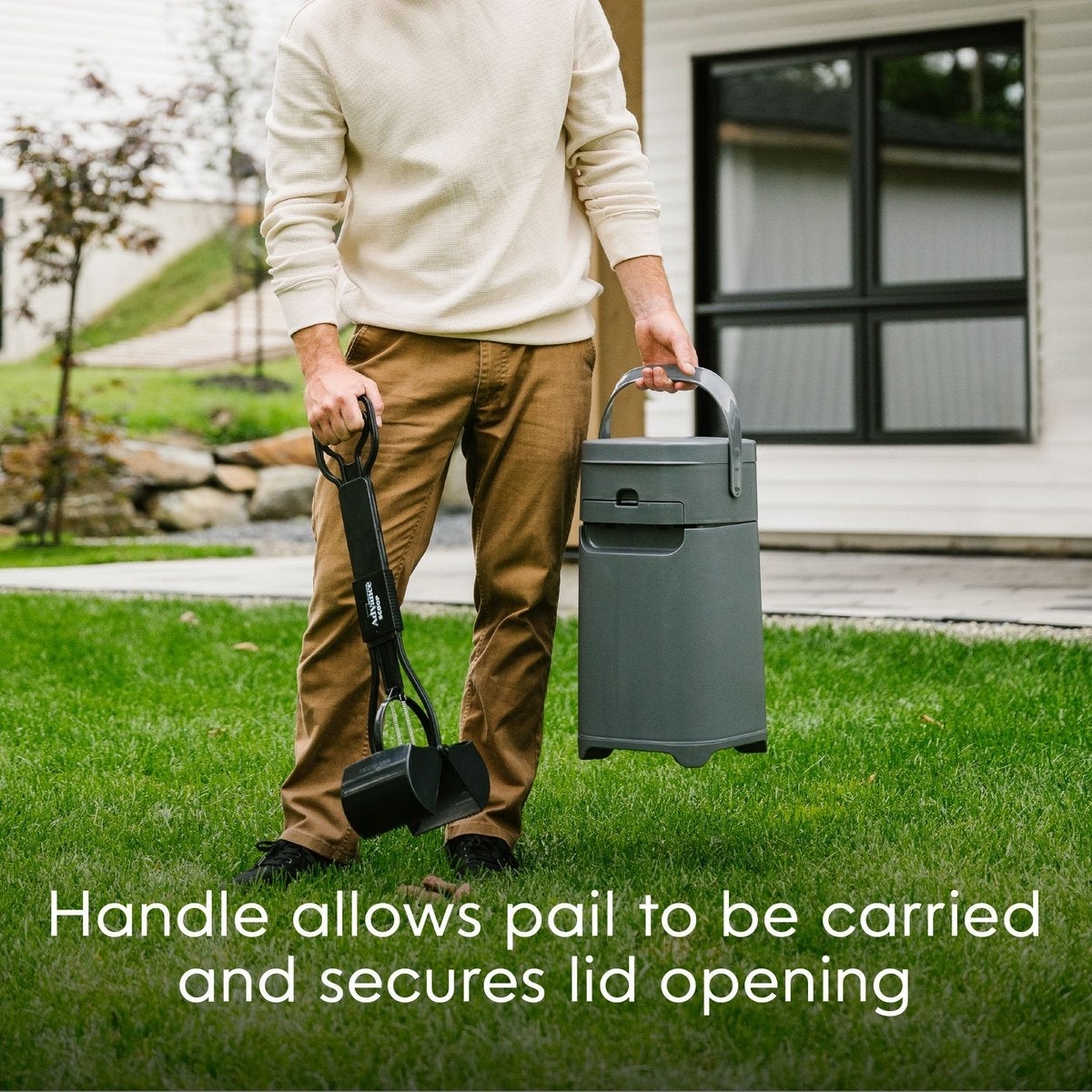 A person holding a pet waste scoop and a gray pail with a secure handle, standing on grass in a backyard. Text highlights the pail's portability and lid