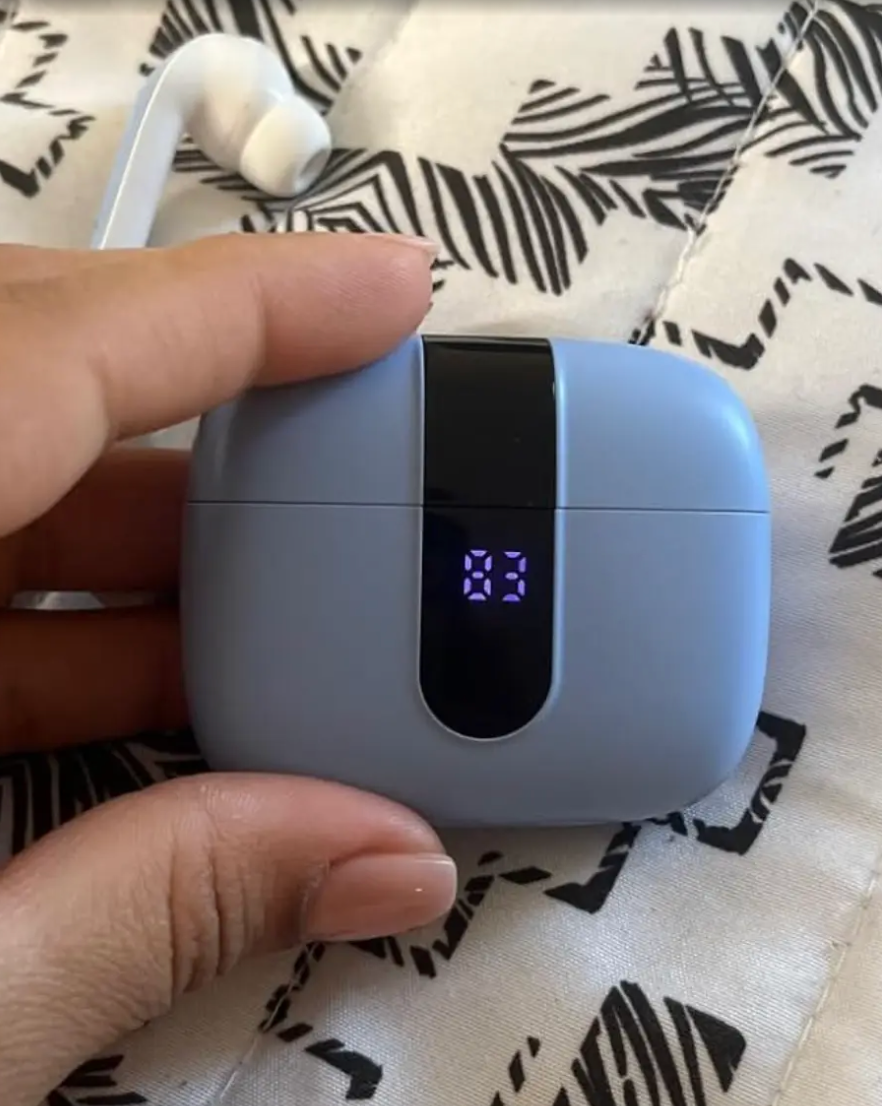 Hand holding wireless earbuds lawsuit  with a integer  show  showing the fig   
