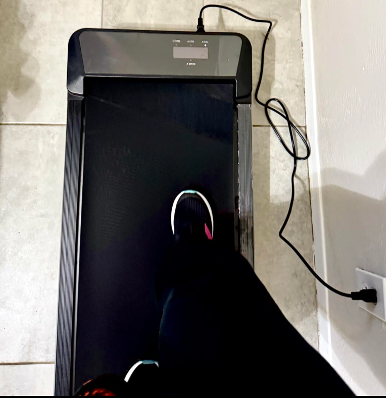 Person walking connected  a sleek, compact treadmill successful  a location  setting, plugged into a adjacent    partition  outlet