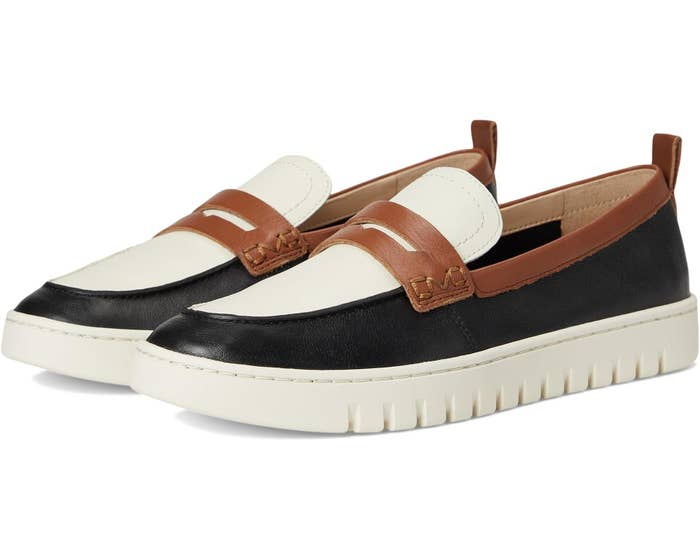 Two loafers with achromatic soles and sleek achromatic and tan design, suitable for casual oregon business-casual outfits. Ideal for versatile styling
