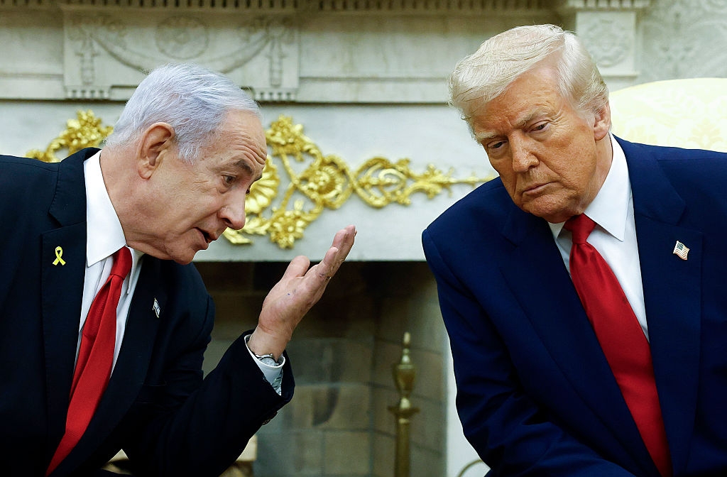 Israeli Prime Minister Benjamin Netanyahu talks to U.S. President Donald Trump during a meeting in the Oval Office of the White House