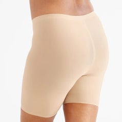 Person wearing seamless, high-waisted beige shapewear shorts, showcasing fit and smooth finish