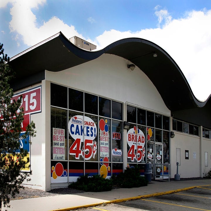 Retro-style building with Hostess snack cakes and bread advertisements displaying "45" on the windows, highlighting discounts