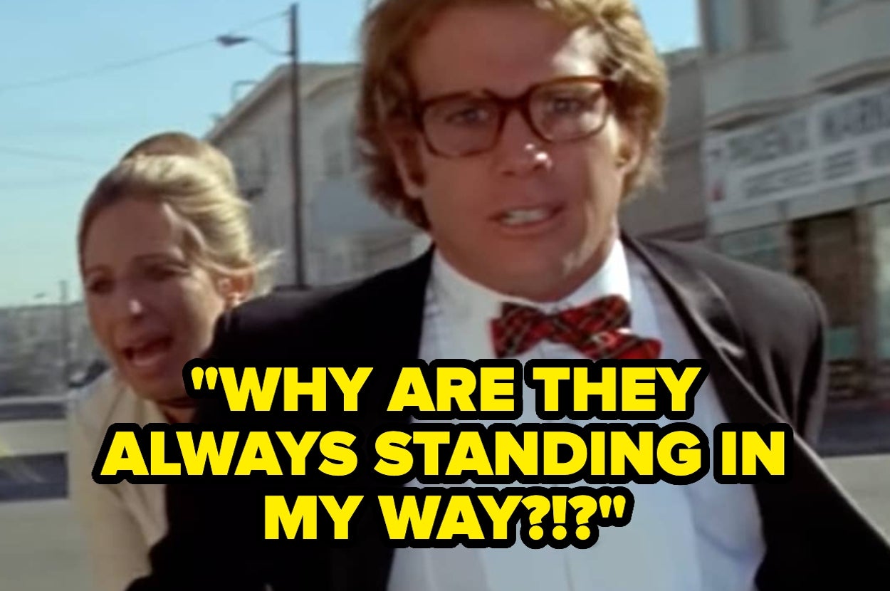Man in glasses and bow tie looks frustrated, with a woman behind him; yellow text reads: "WHY ARE THEY ALWAYS STANDING IN MY WAY?!?"