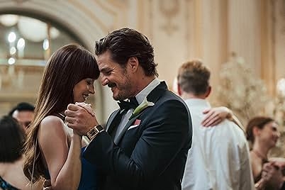 A couple elegantly dressed in formal attire dances closely at an upscale event, sharing a joyful moment