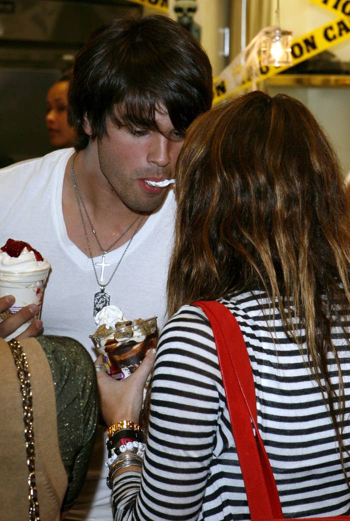 Miley Cyrus and Justin Gaston sharing a dessert